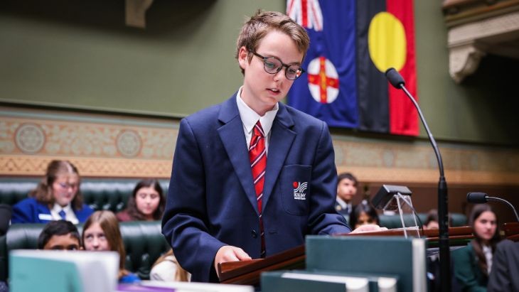 A student speaking at a lectern.