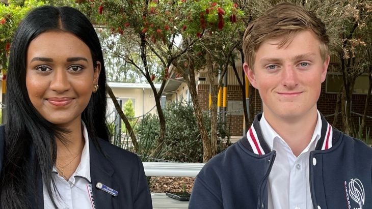 A female and male student in uniform.