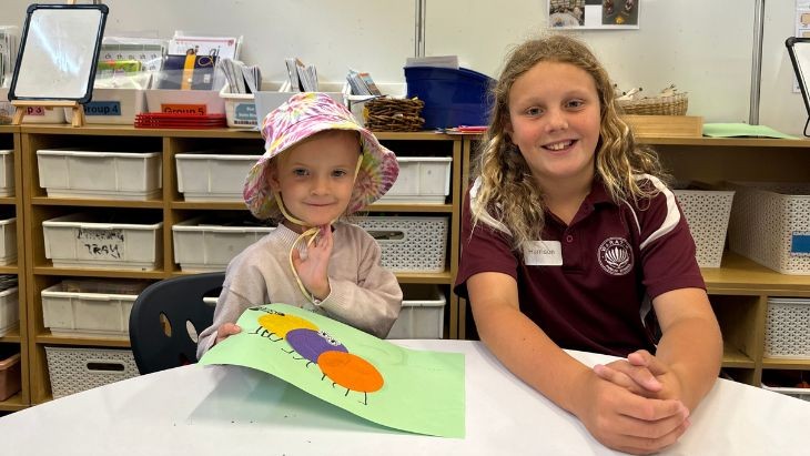 Two students sitting at a table.