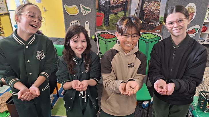 Students holding worms in their hands.
