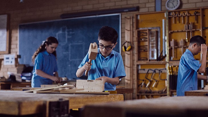 3 students in a woodwork class.