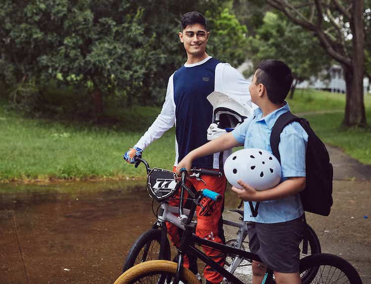 Kai Sakakibara and primary school boy walking in the park with their bikes