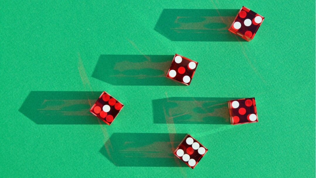 Five dice on a green background