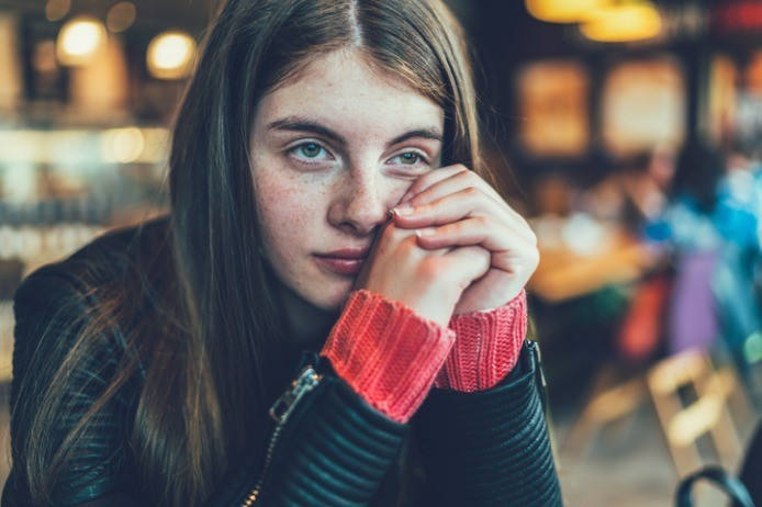 Teenage girl looking worried and depressed