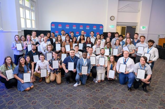 60 infrastructure traineeship graduates holding their certificates in their hands
