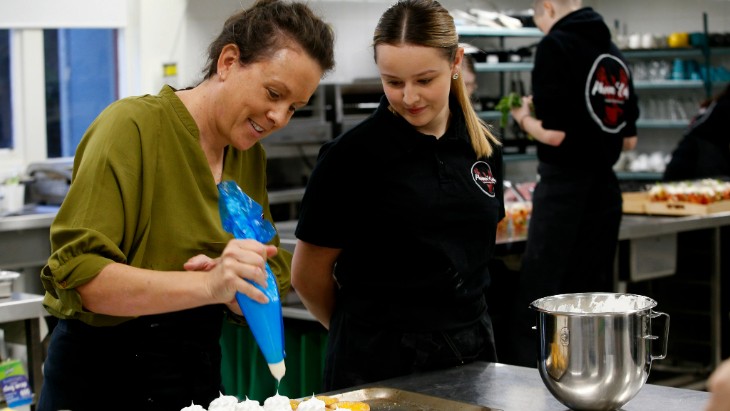 A school-based apprentice and her hospitality teacher in the kitchen. 