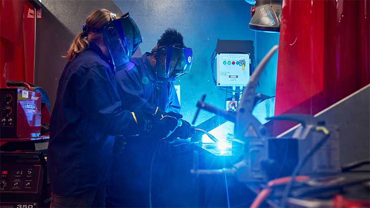 Two apprentices welding.
