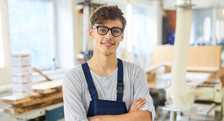 Male student with arms folded looking at the camera.