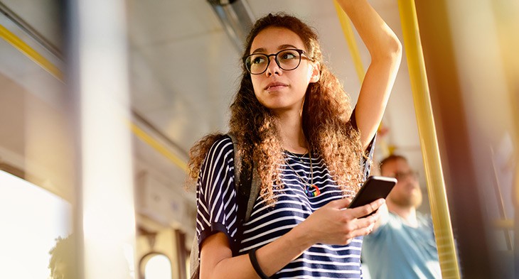 Female holding on in bus.