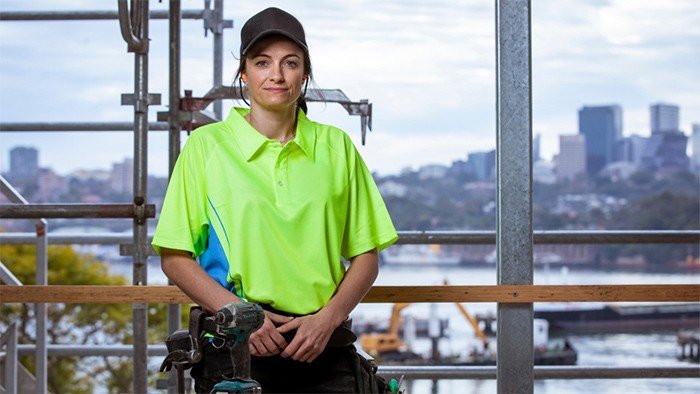 Female apprentice carpenter on construction site