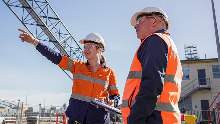 Female apprentice and supervisor on a construction site. 