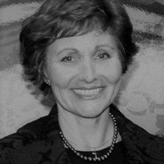Black and white image of Sandra Lynch looking at the camera