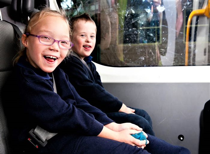 Two children sitting in a vehicle.