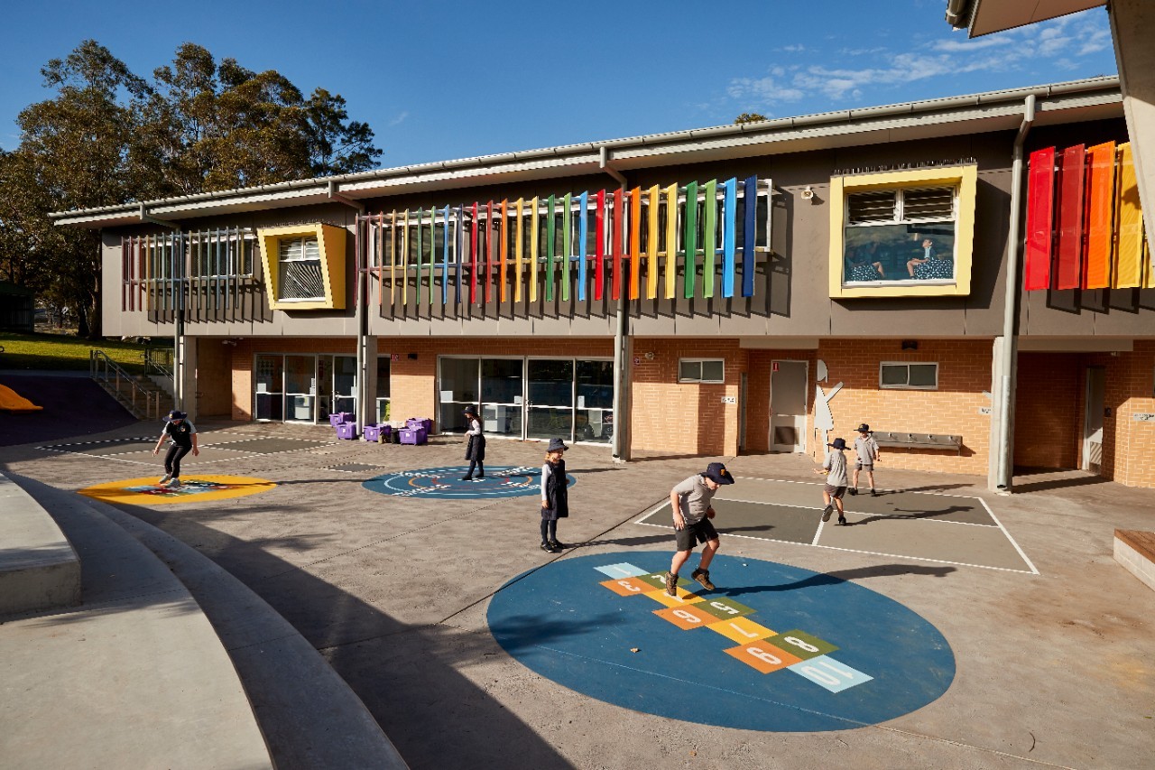 Image of children playing outside a school building