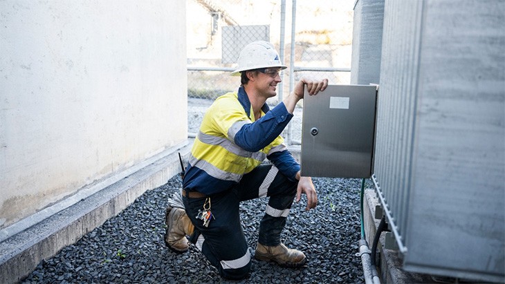 Renewable energy worker inspecting power installation