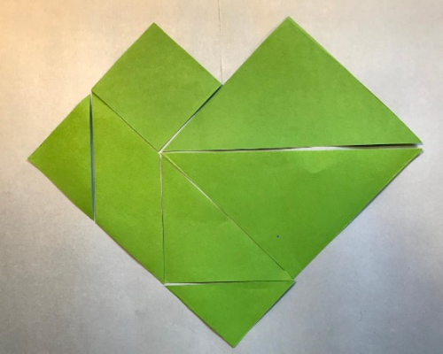 a heart shape made of tangram pieces
