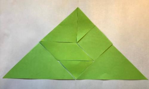 a large triangle made of tangram pieces