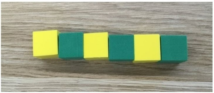 a row of blocks with alternate green and yellow blocks