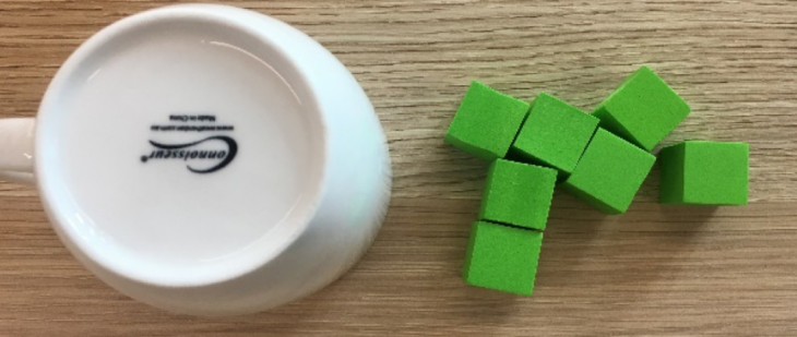 An upside down cup and random 7 blocks on the side