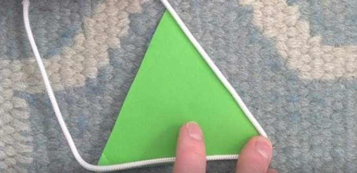 a green triangle with measure rope
