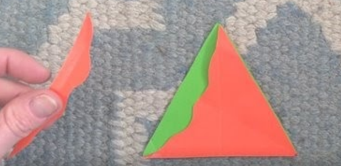 a green triangle with a squiggly side triangle on top of it