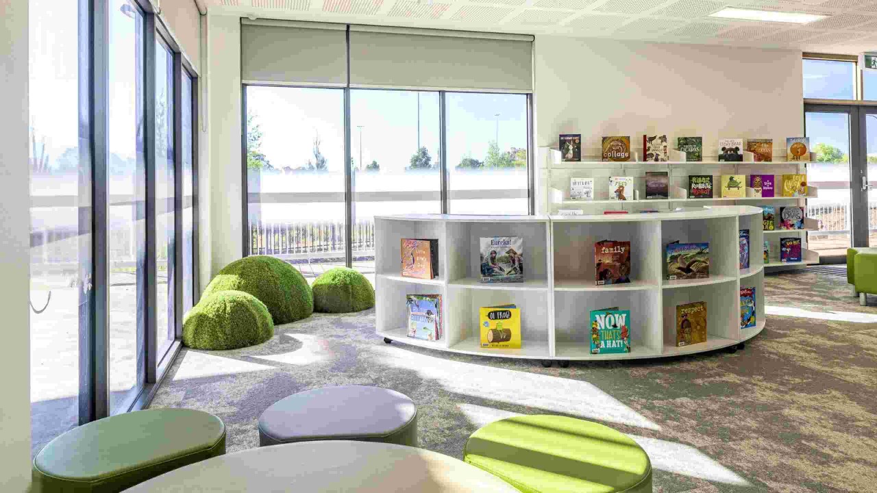 Image of a library with books on shelves and seating.