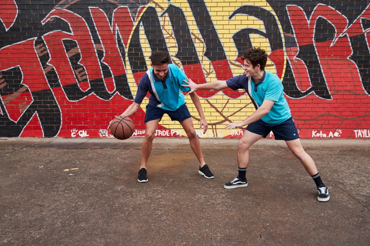 Students playing basketball outside