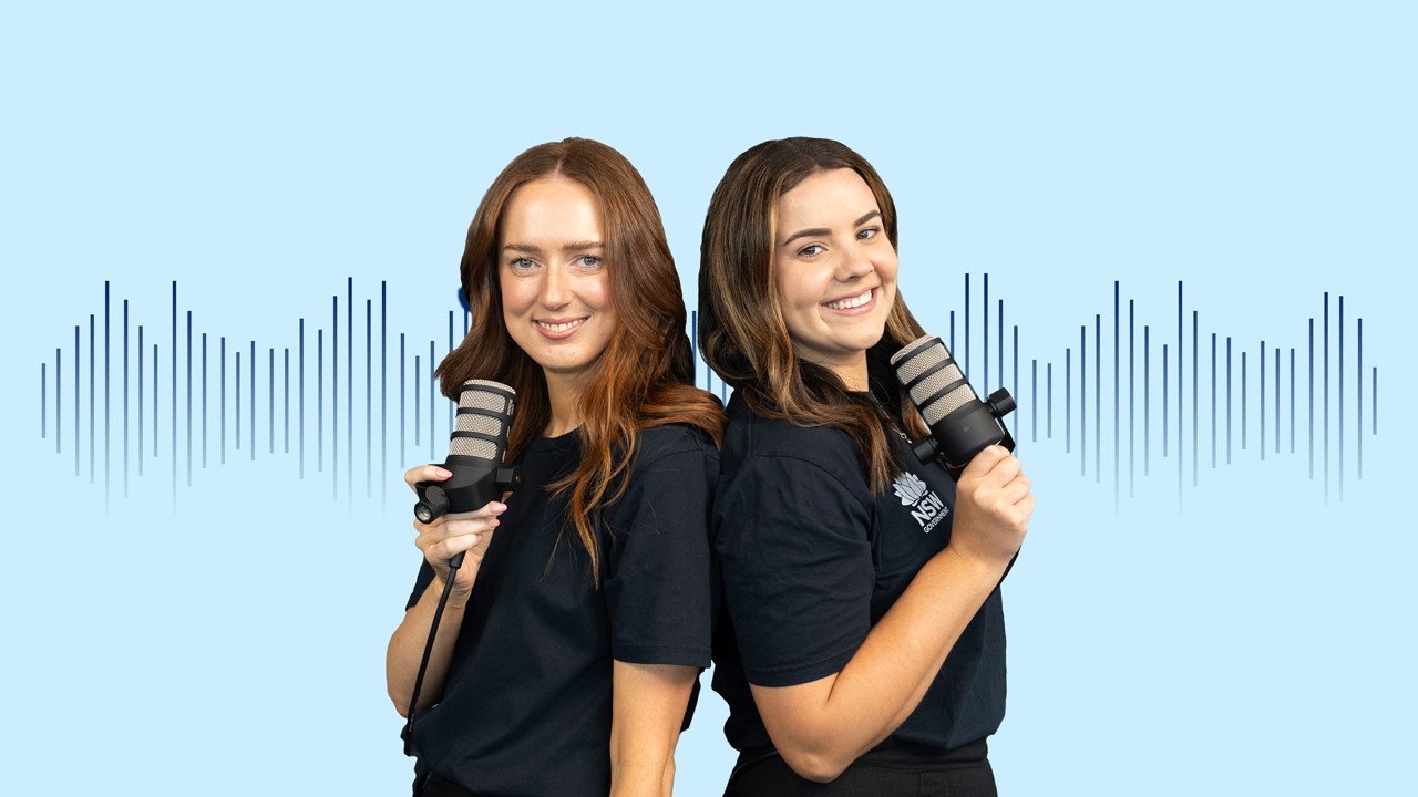Shannon_and_Siobhan_1280x720_v9 Two females holding microphones smiling at the camera
